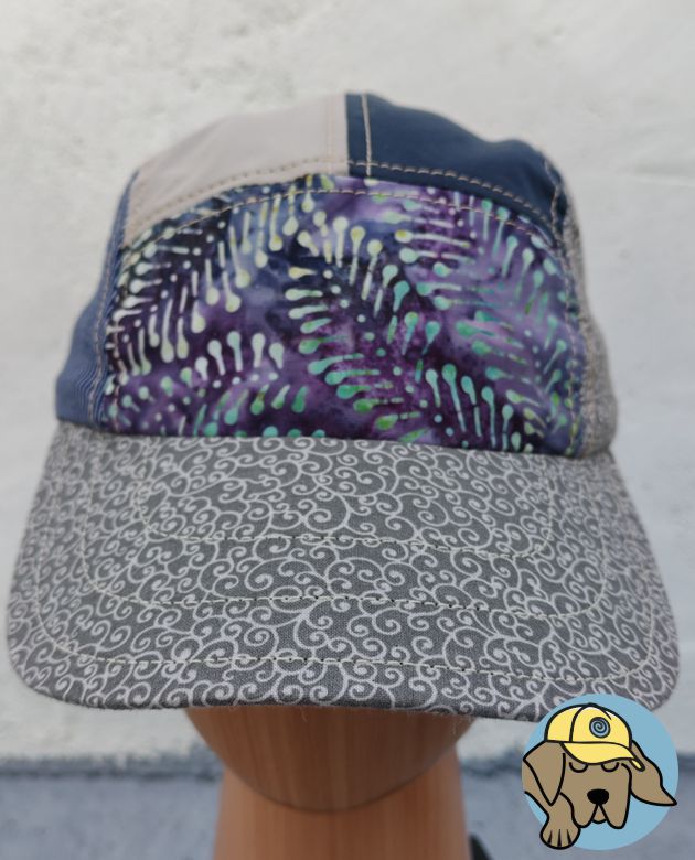 front view of 5 panel hat no 211 showing purple batik front panel